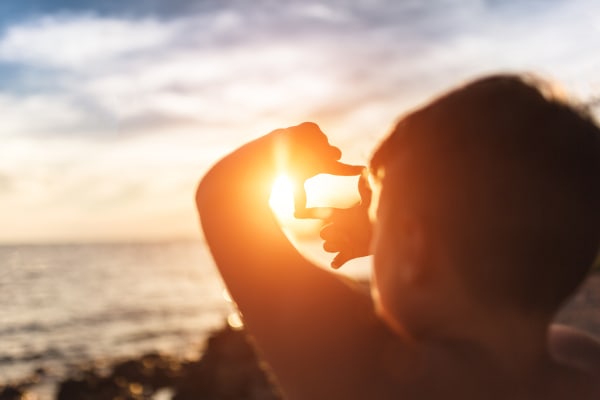 Young person studies the sun